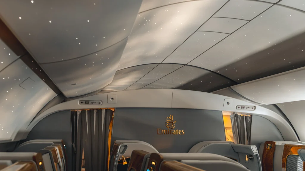 Emirates First Class cabin with signature starlit ceiling lighting and luxury seating on board the Airbus A380.